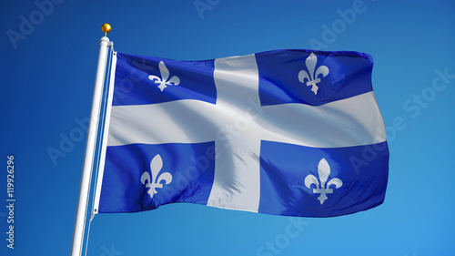 Quebec flag waving against clean blue sky, close up, isolated with clipping path mask alpha channel transparency photo