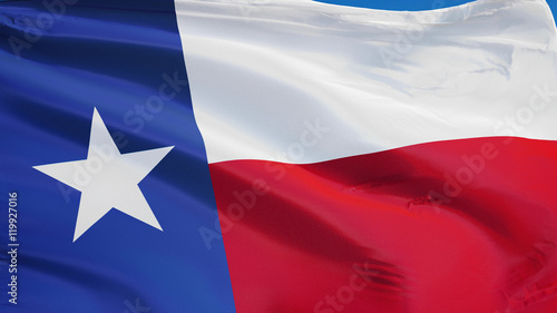 Texas flag waving against clean blue sky, close up, isolated with clipping path mask alpha channel transparency