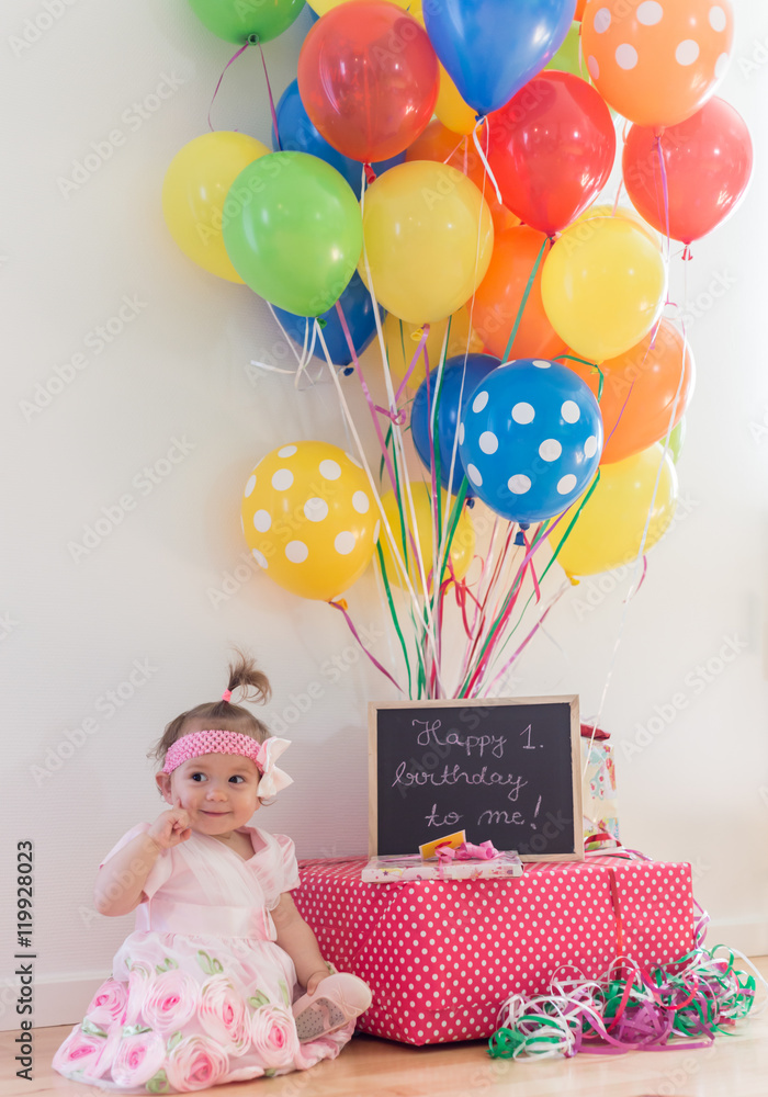 First birthday,beautiful little princesse celebrating her first birthday among the balloons and