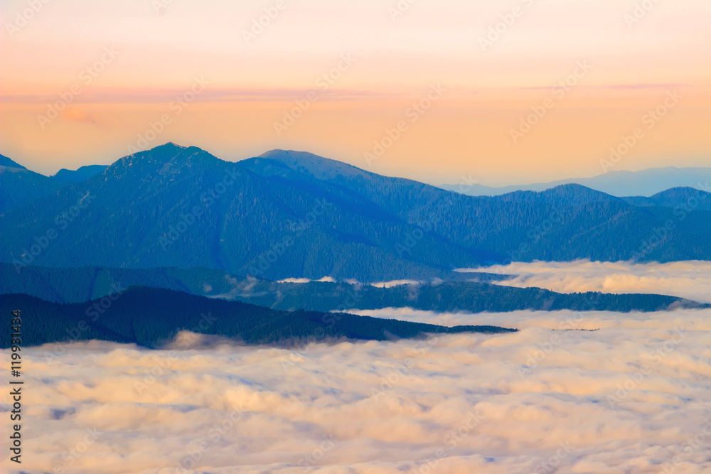 Picturesque sunrise morning in mountains above clouds, Carpathians, Ukraine.