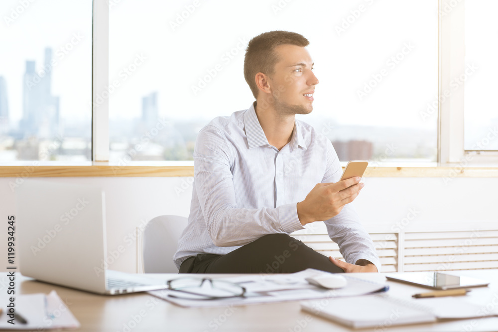 Fototapeta premium Caucasian businessman using smartphone