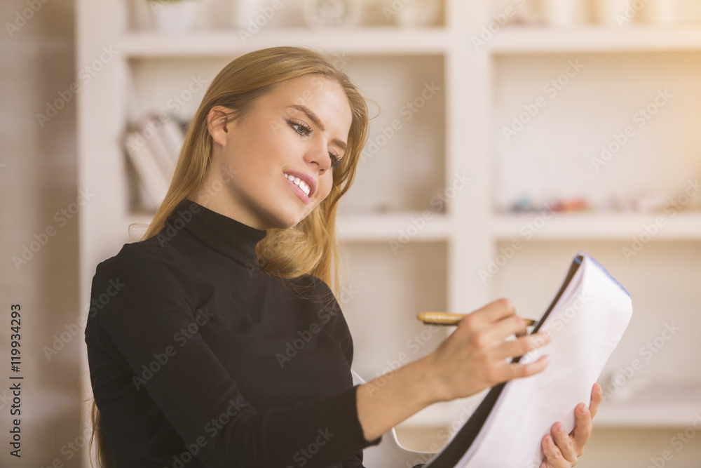 Cheerful designer examining interior project Cheerful designer examining interior project