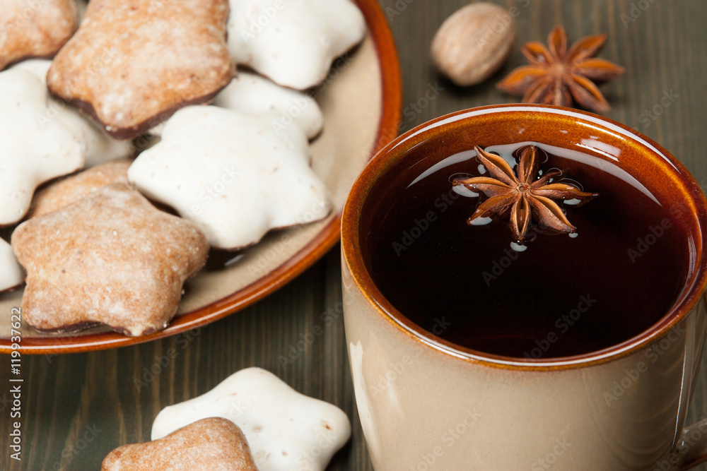 Fototapeta premium Mug Of Tea Or Coffee. Spices. Gingerbread Star Cookies With Icin