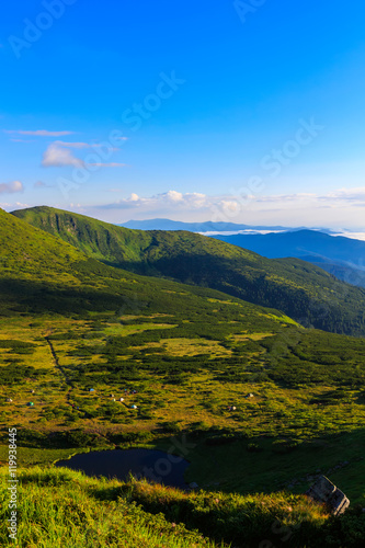 Carpathian mountains landscape in morning, view from the height, Nesamovyte lake under hill.
