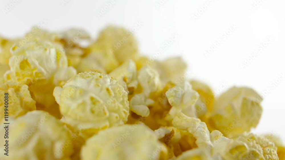 Salt popcorn in box on white background, rotation, very close up Salt popcorn in box on white background, rotation, very close up