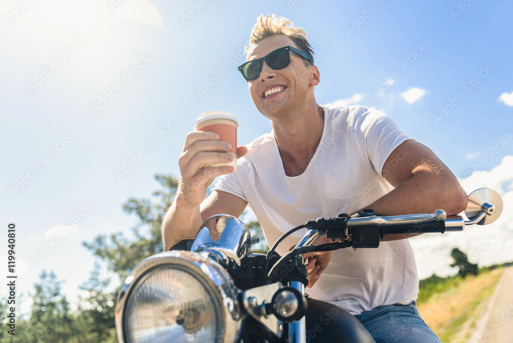 Young man sitting on his motorbike