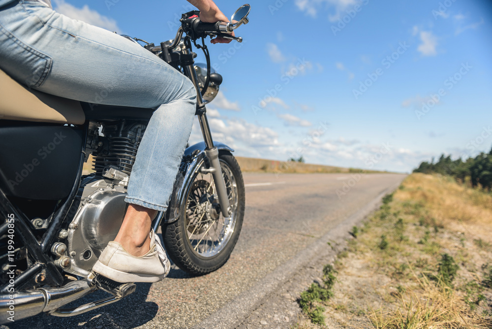 Young man riding his motorbike on open road Young man riding his motorbike on open road