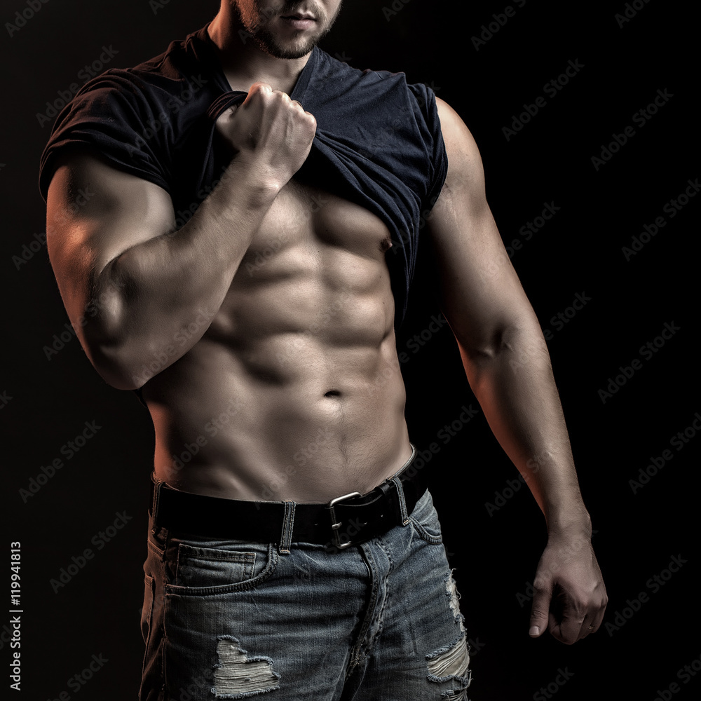 Muscular man with shirt on shoulder