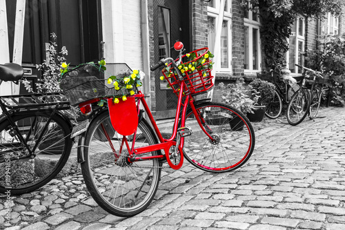 Fototapeta Naklejka Na Ścianę i Meble -  Retro vintage red bicycle on cobblestone street in the old town.