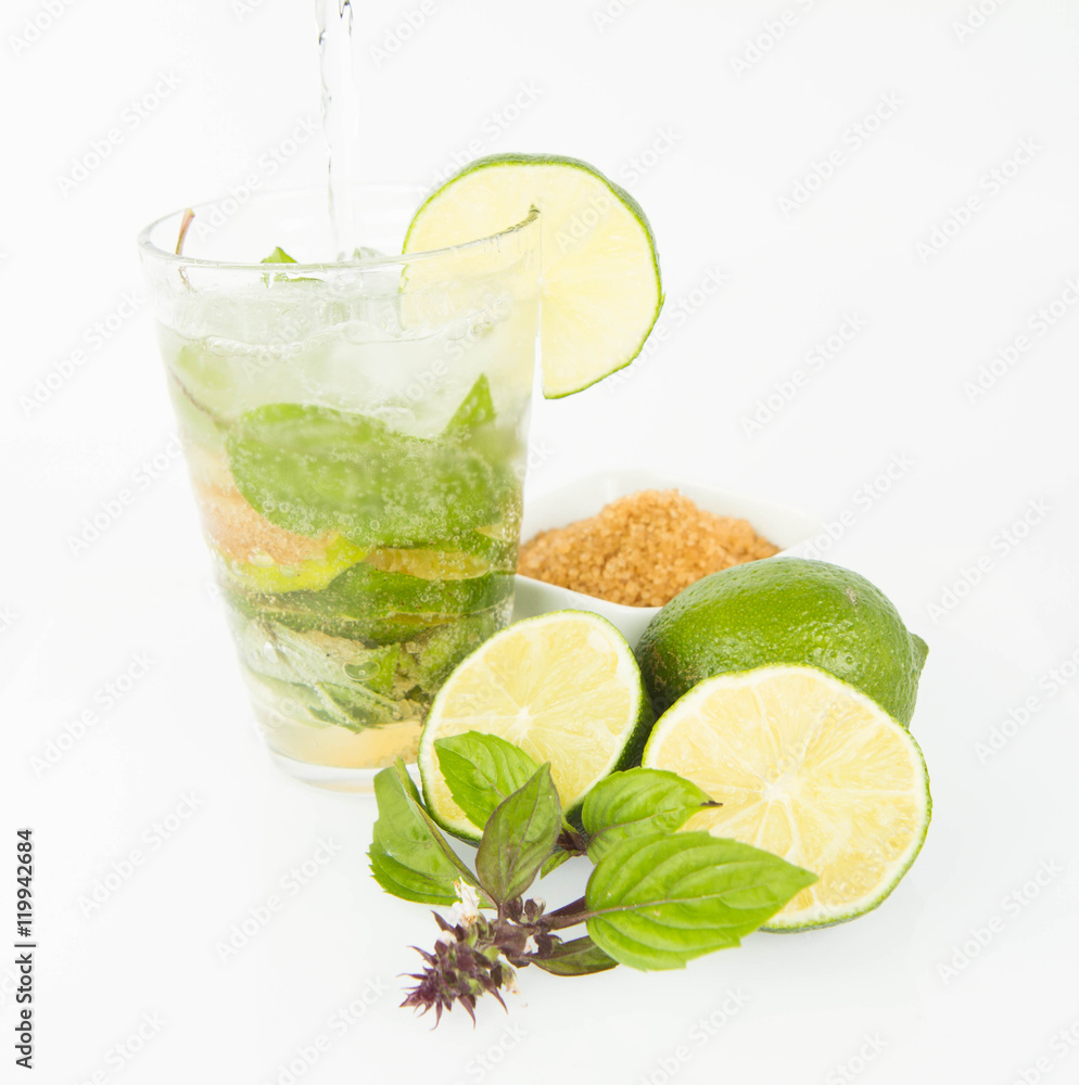 Mojito in a glass and ingredients on a white background