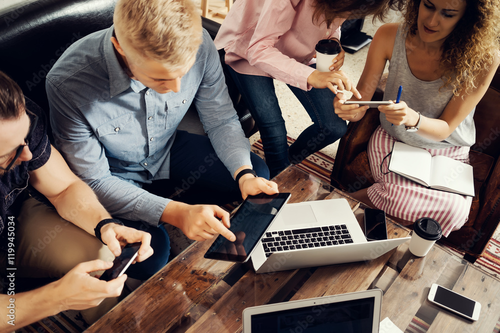 Fototapeta premium Group Young Coworkers Making Great Business Decisions.Creative Team Discussion Corporate Work Concept Modern Studio Loft.New Startup Marketing Idea Presentation.People Touching Screen Digital Gadgets.