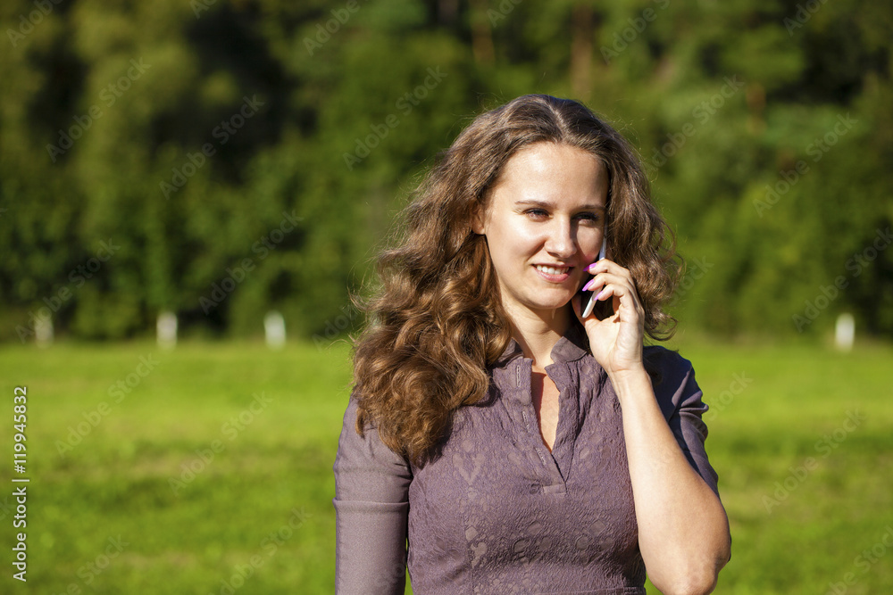 Portrait of beautiful dark haired young woman speaking on mobile Portrait of beautiful dark haired young woman speaking on mobile
