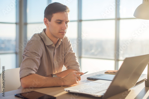 Man freelancer businessman working on laptop computer in office.