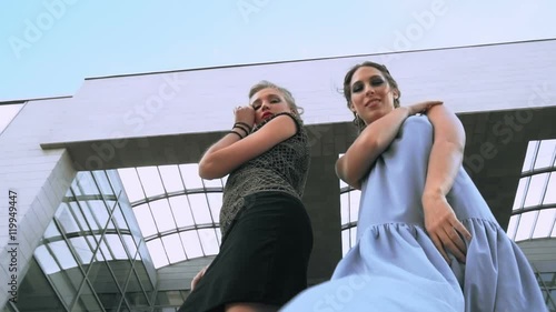 The girls posing together and whirling in front of camera with down angle photo