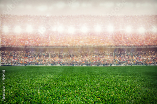 green grass stadium on supporters background