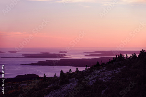 pink twilight sky before sunrise above Atlantic Ocean with island silhouette