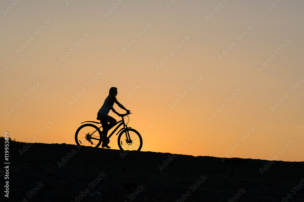 Cyclist Girl on beautiful sunset.