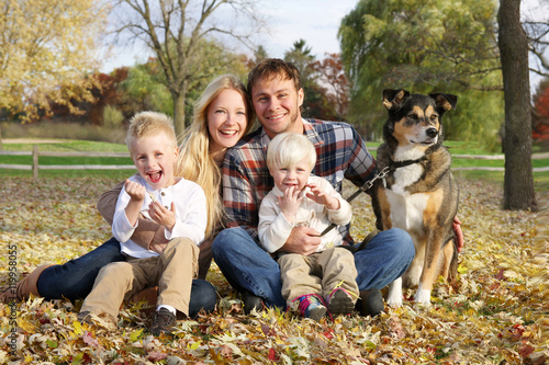 Happy Family of Four People and Dog OUtside in Autumn
