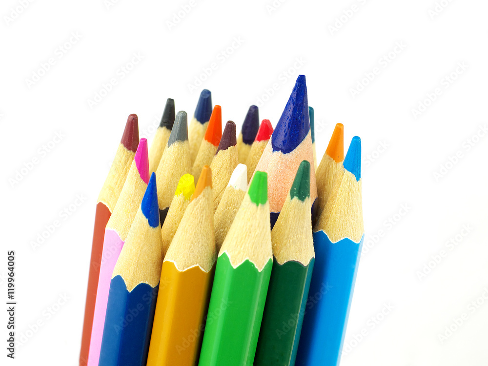 Set of color pencils on white background, macro, shallow depth of field, focus on the biggest pencil Set of color pencils on white background, macro, shallow depth of field, focus on the biggest pencil