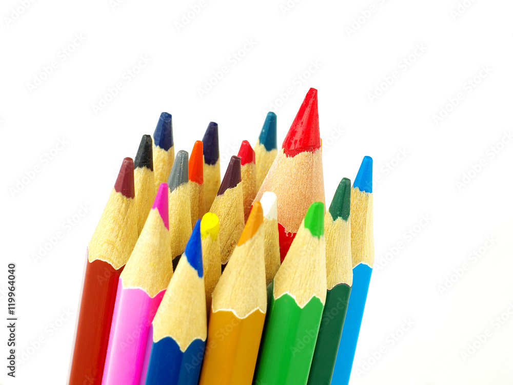 Set of color pencils on white background, macro, shallow depth of field, focus on the biggest pencil