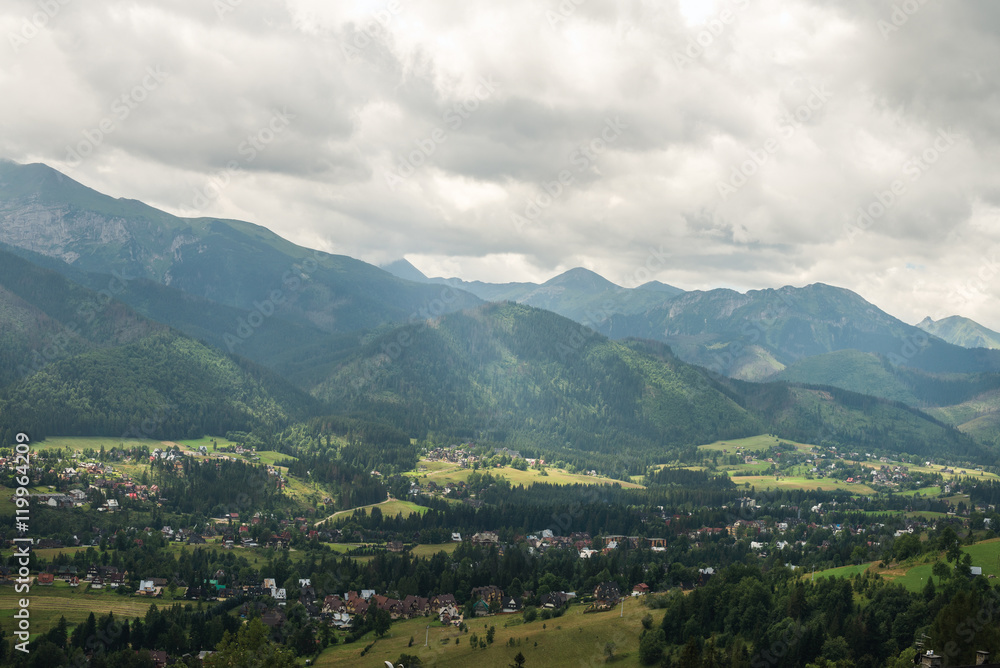 View over green valley, village and mountains. Zakopane, Tatry mountains, Poland