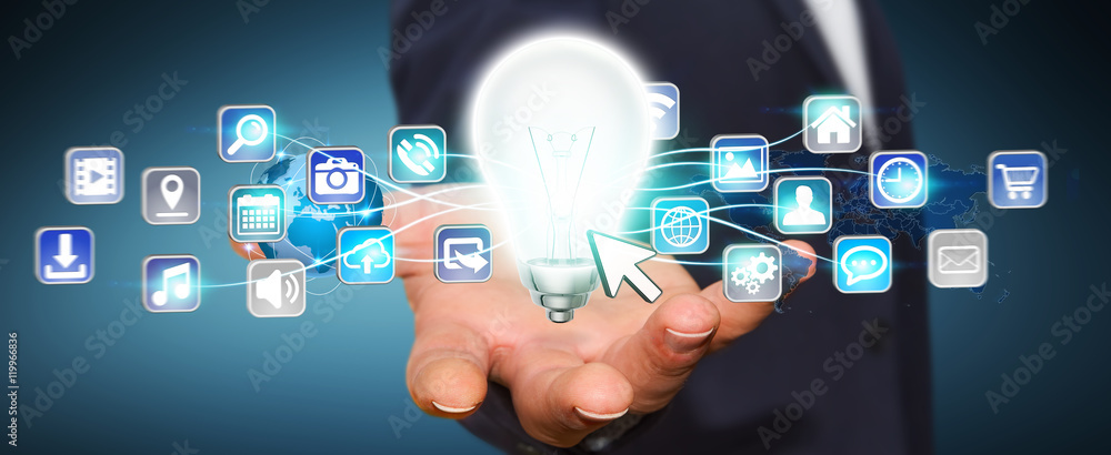 Businessman holding lightbulb with digital icons Businessman holding lightbulb with digital icons