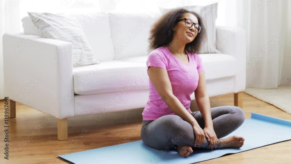 happy african woman exercising on mat at home happy african woman exercising on mat at home