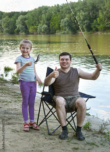people camping and fishing, family leisure in nature, fish caught on bait, river and forest, summer season