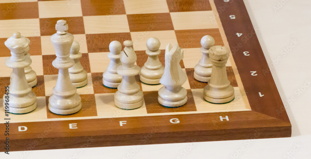 Chess board with white pieces on a white background Chess board with white pieces on a white background