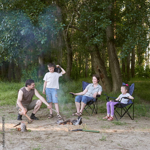 people camping in forest, family active in nature, kindle fire, summer season