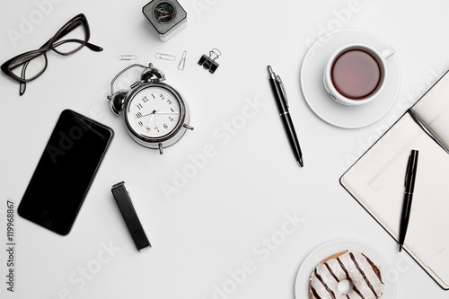 Office desk table with cup, supplies, phone on white background