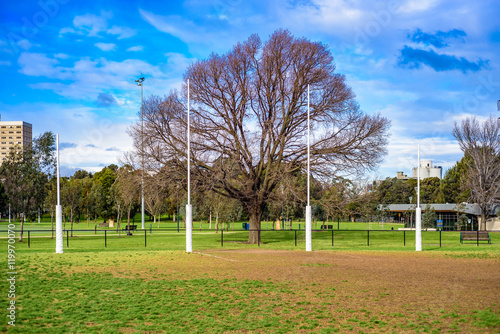 Australian Football League goal posts in a park photo