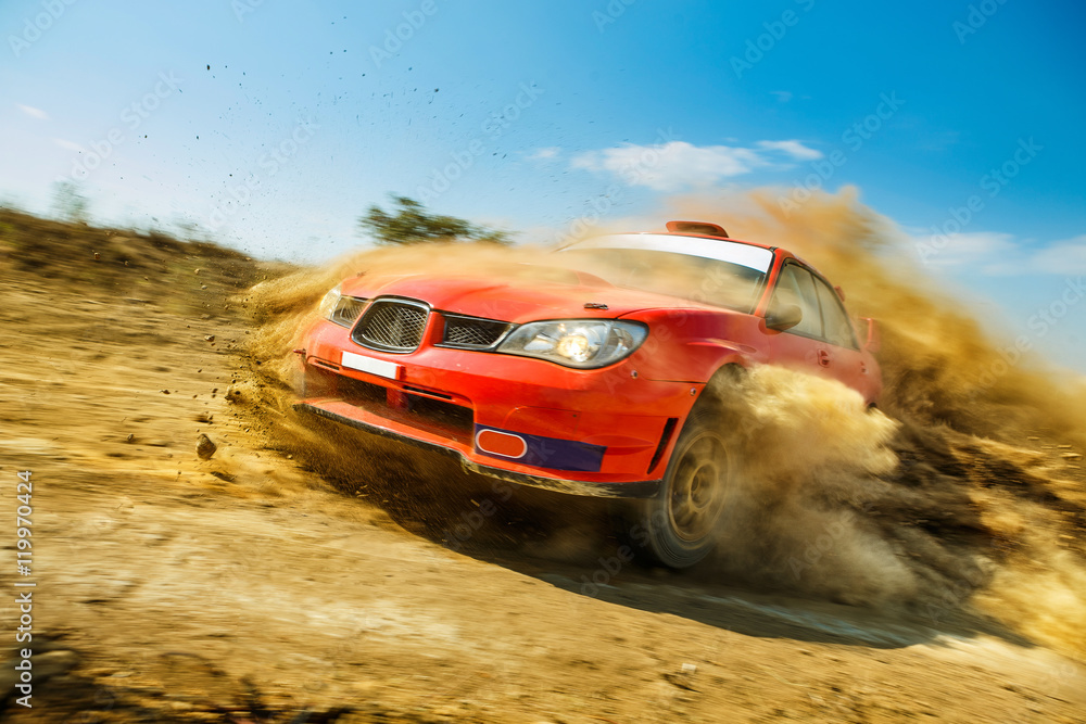 Powerful red rally car in the drift on dirt road