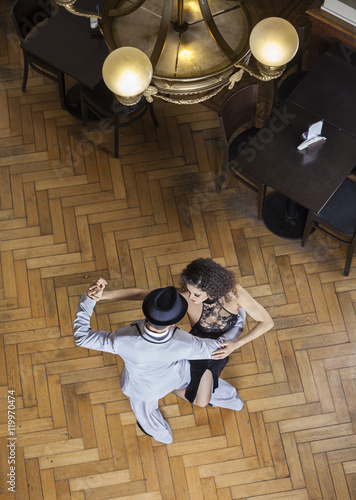 High Angle View Of Tango Dancers Performing On Wooden Floor