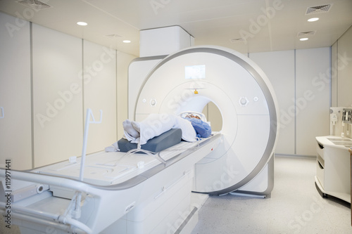 Female Patient Undergoing MRI Scan In Hospital