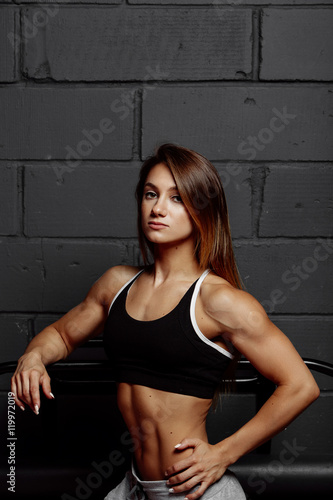 Muscular body of a young woman  abs close up. Woman s abs