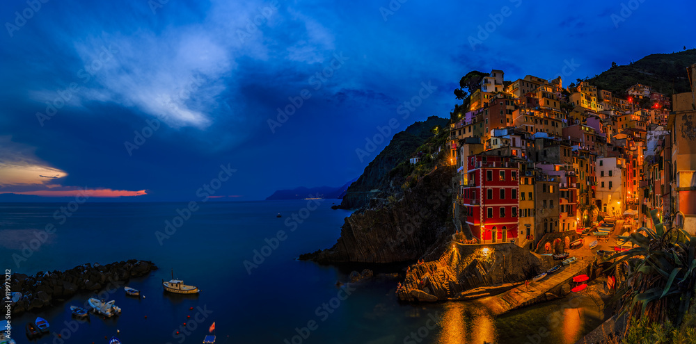 Amazing night view of Riomaggiore one of the five villages of the Cinque Terre on Italy mediterranean coast.
