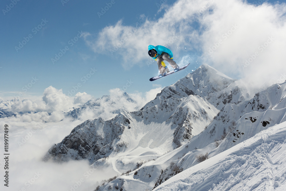 Snowboarder jumping on mountains. Extreme sport.