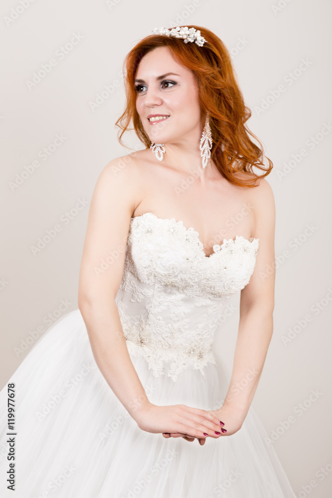 red-haired bride in a wedding dress, bright unusual appearance. Beautiful wedding hairstyle and bright make-up red-haired bride in a wedding dress, bright unusual appearance. Beautiful wedding hairstyle and bright make-up
