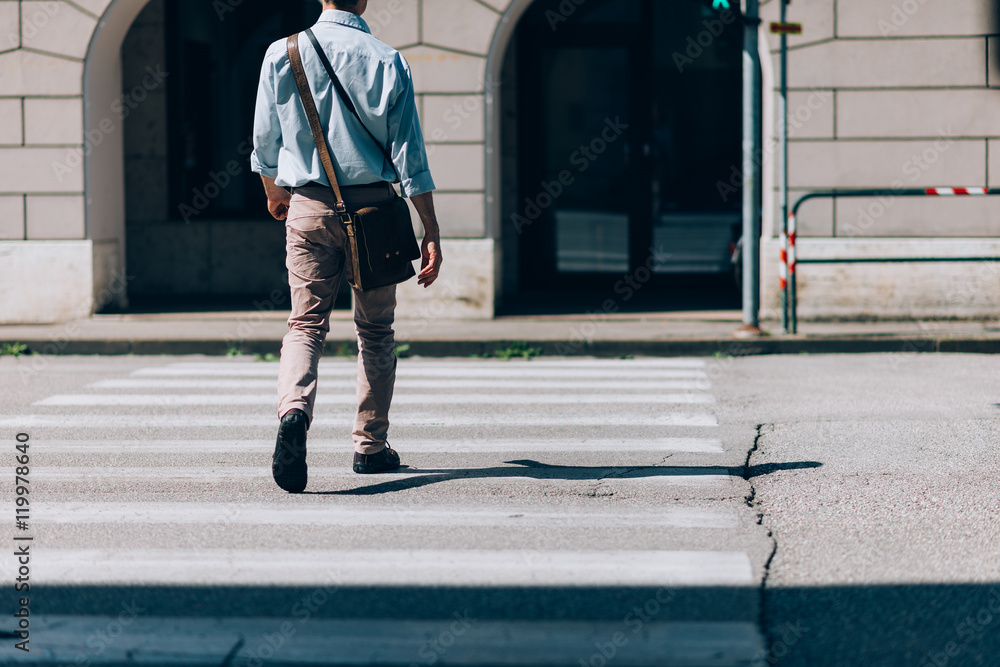 © stokkete - Man crossing the street