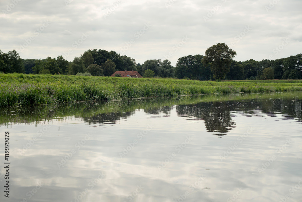 Dutch river de Berkel with dyke and farm. Achterhoek. Gelderland