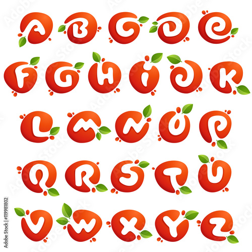 Alphabet letters in fresh juice splash with green leaves.