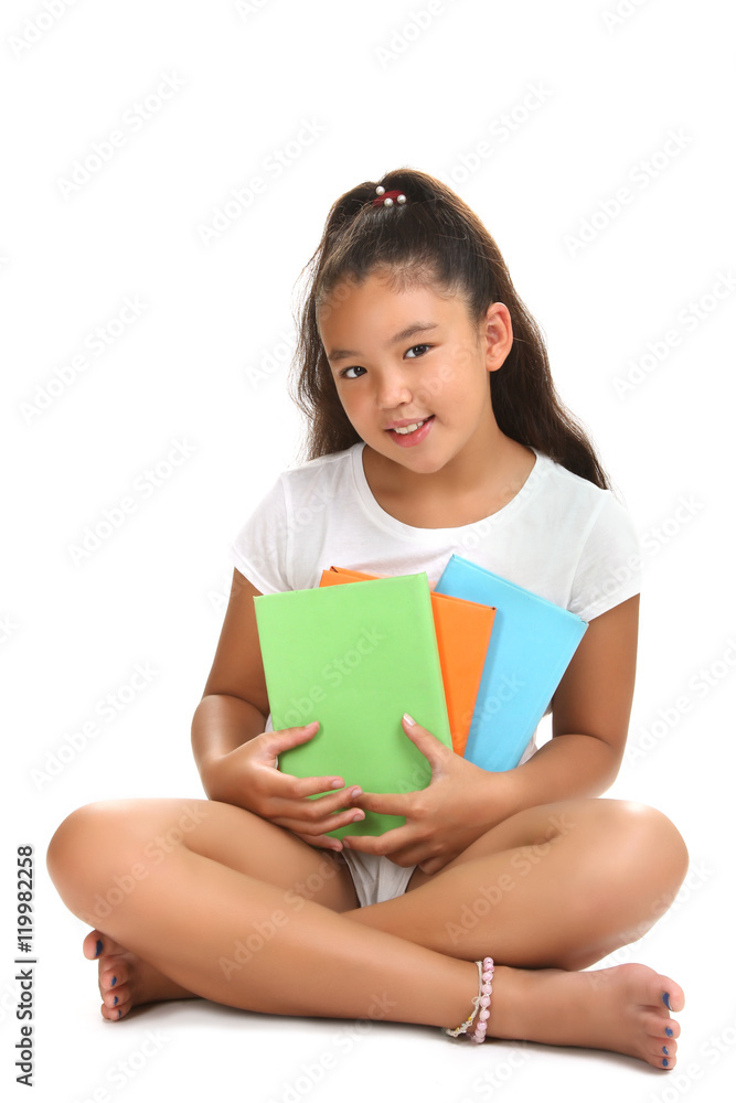 Happy little girl sitting on the floor and reading a book. Isolated on white background Happy little girl sitting on the floor and reading a book. Isolated on white background