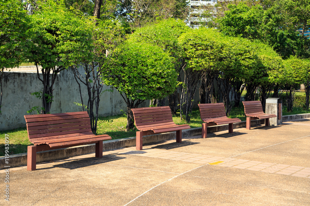 Wooden bench in city park. Wooden bench in city park.