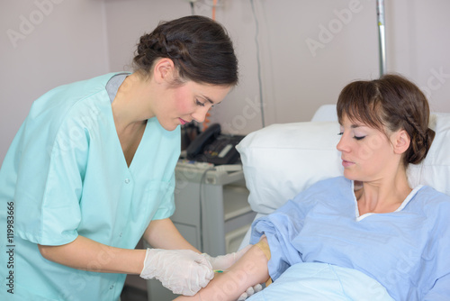 Nurse holding patient's arm