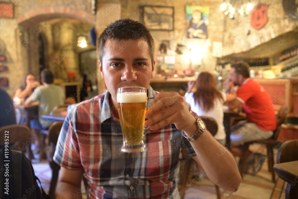 Man drinking beer at a bar Man drinking beer at a bar