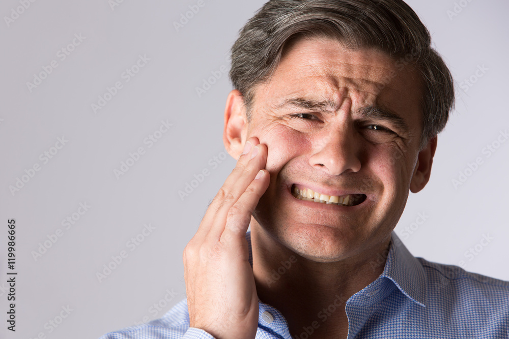 Studio Portrait Of Man Suffering With Toothache Studio Portrait Of Man Suffering With Toothache