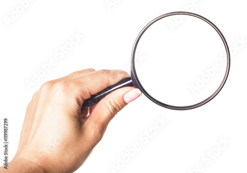 Hand holding magnifying glass isolated on white background