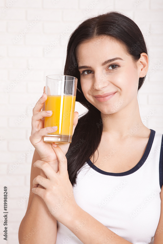 Woman drinking orange juice Beautiful mixed-race Asian, Caucasian model. Woman drinking orange juice Beautiful mixed-race Asian, Caucasian model.