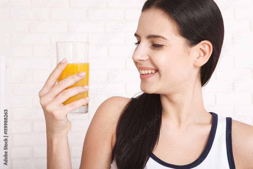 Woman drinking orange juice Beautiful mixed-race Asian, Caucasian model. Woman drinking orange juice Beautiful mixed-race Asian, Caucasian model.